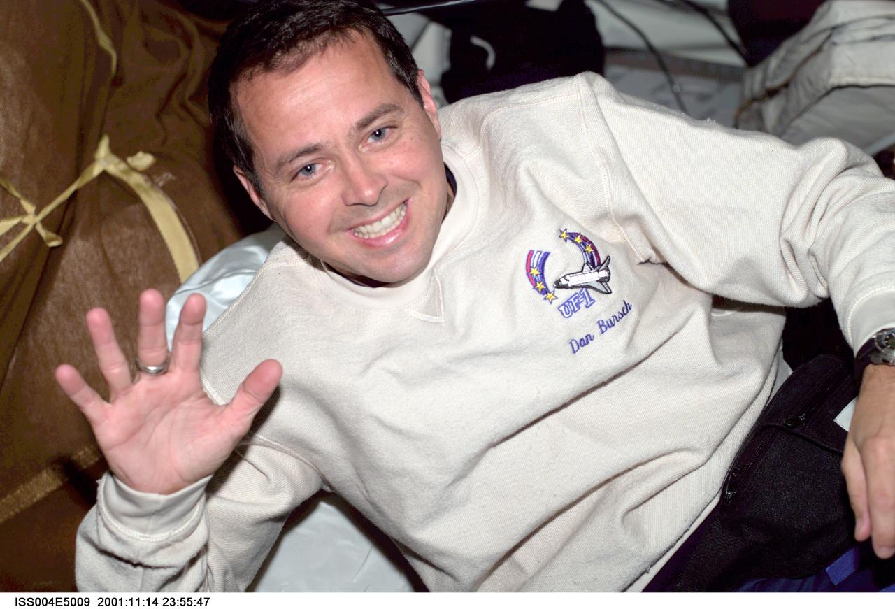 ISS004-E-5009 (December 2001) --- Astronaut Daniel W. Bursch, Expedition Four flight engineer, is photographed with stowage bags on the mid deck of the Space Shuttle Endeavour. The image was taken with digital still camera.