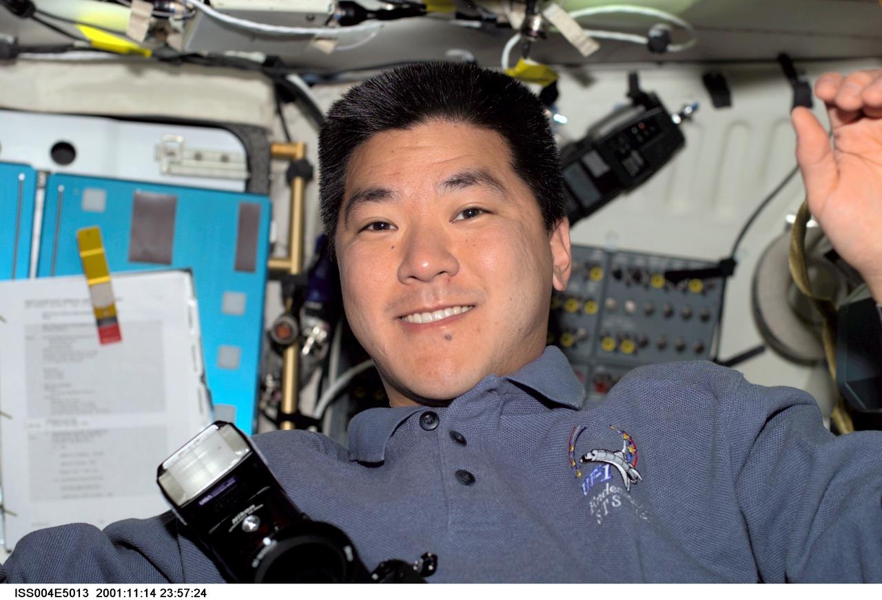 ISS004-E-5013 (December 2001) --- Astronaut Daniel M. Tani, STS-108 mission specialist, is photographed on the mid deck of the Space Shuttle Endeavour. The image was taken with a digital still camera.