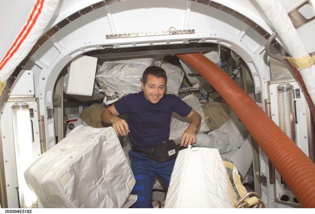 ISS004-E-5182 (December 2001) --- Astronaut Daniel W. Bursch, Expedition Four flight engineer, is photographed among stowage bags in the Quest Airlock on the International Space Station (ISS) during early phase of his scheduled stint on the orbital outpost. The image was taken with a digital still camera.