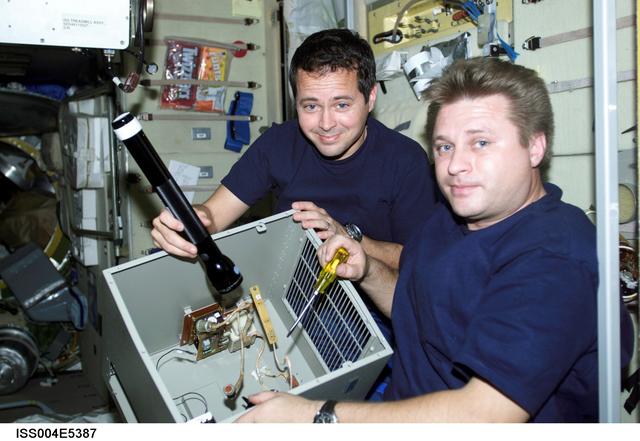 NASA image: Onufrienko and Bursch perform IFM on SM Potok air purification unit during Expedition Four