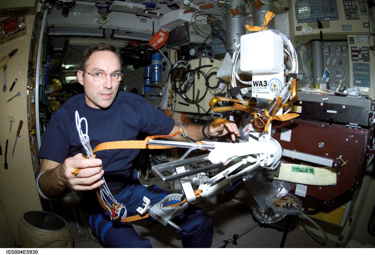 ISS004-E-5930 (January 2002) --- Astronaut Carl E. Walz, Expedition Four flight engineer, works with the Amateur Radio (HAM) WA3 Antenna Assembly in the Zvezda Service Module on the International Space Station (ISS). The image was taken with a digital still camera.