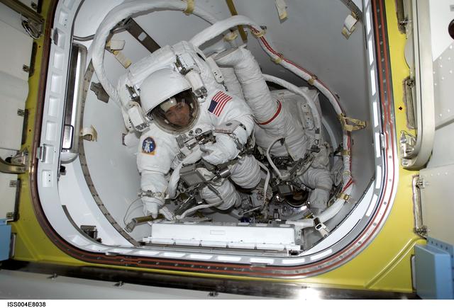 NASA image: Bursch and Walz in Quest Airlock for EVA 3, Expedition Four