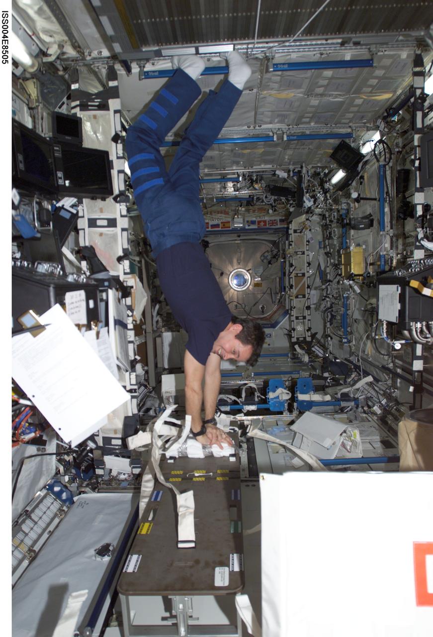 ISS004-E-8505 (11 March 2002) --- Astronaut Daniel W. Bursch, Expedition Four flight engineer, performs cardio-pulmonary resuscitation (CPR) on a jerry-rigged “human chest” dummy in the Destiny laboratory on the International Space Station (ISS). The image was taken with a digital still camera.