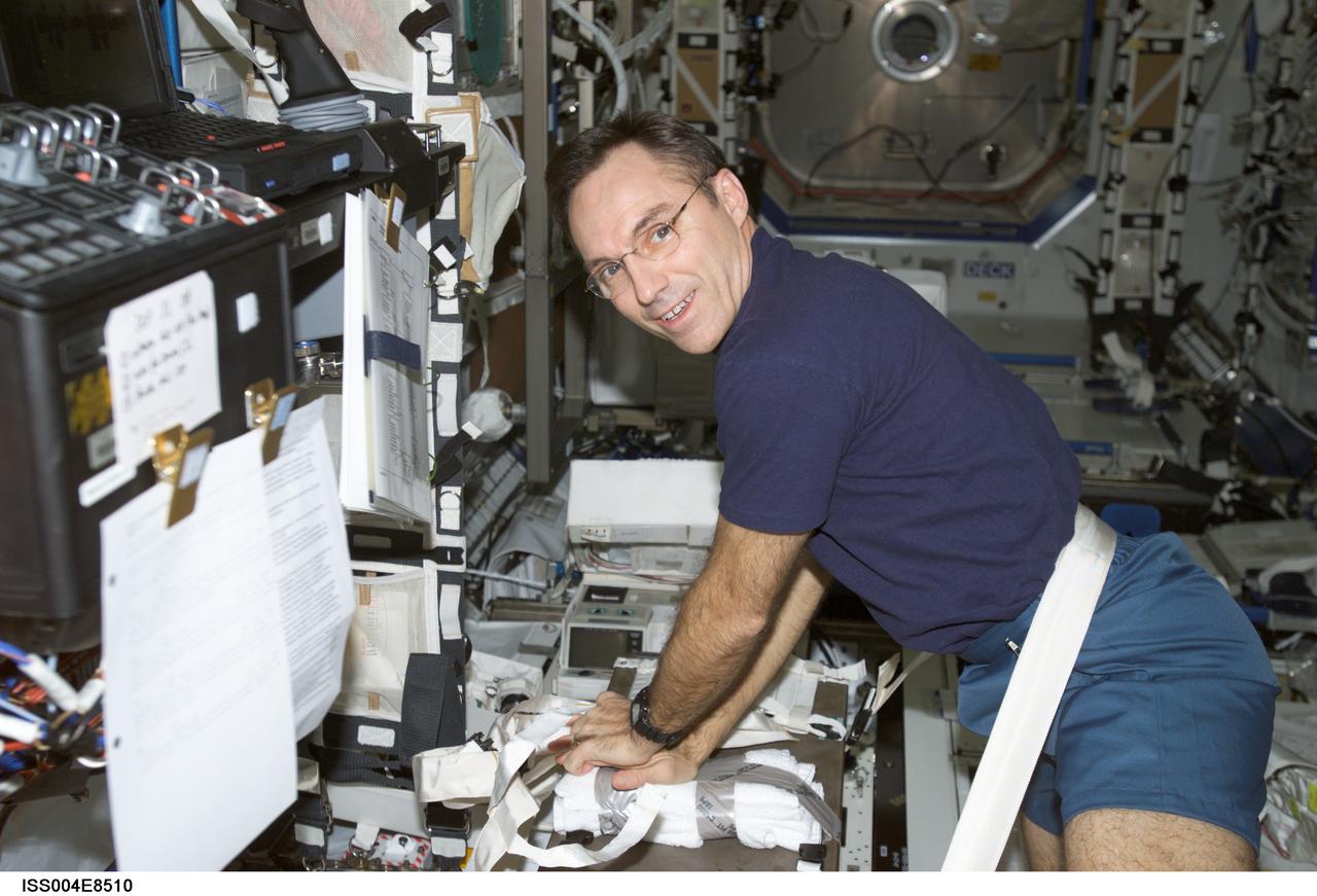 ISS004-E-8510 (11 March 2002) --- Astronaut Carl E. Walz, Expedition Four flight engineer, performs cardio-pulmonary resuscitation (CPR) on a jerry-rigged &#0147;human chest&#0148; dummy in the Destiny laboratory on the International Space Station (ISS). The image was taken with a digital still camera.