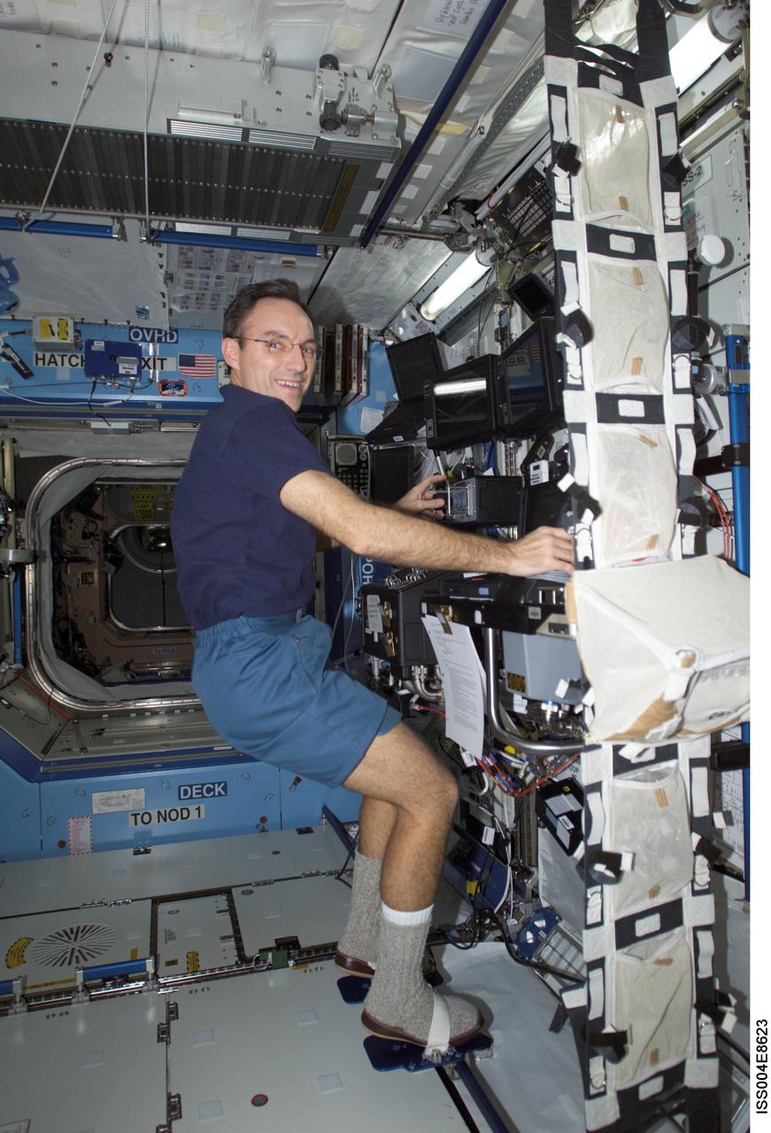 ISS004-E-8623 (14 March 2002) --- Astronaut Carl E. Walz, Expedition Four flight engineer, works the controls of the Canadarm2, or Space Station Remote Manipulator System (SSRMS) in the Destiny laboratory on the International Space Station (ISS). This image was taken with a digital still camera.