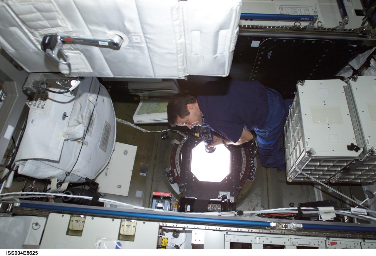 ISS004-E-8625 (14 March 2002) --- Astronaut Daniel W. Bursch, Expedition Four flight engineer, takes Earth observation photos from the Destiny laboratory on the International Space Station (ISS). The image was taken with a digital still camera.