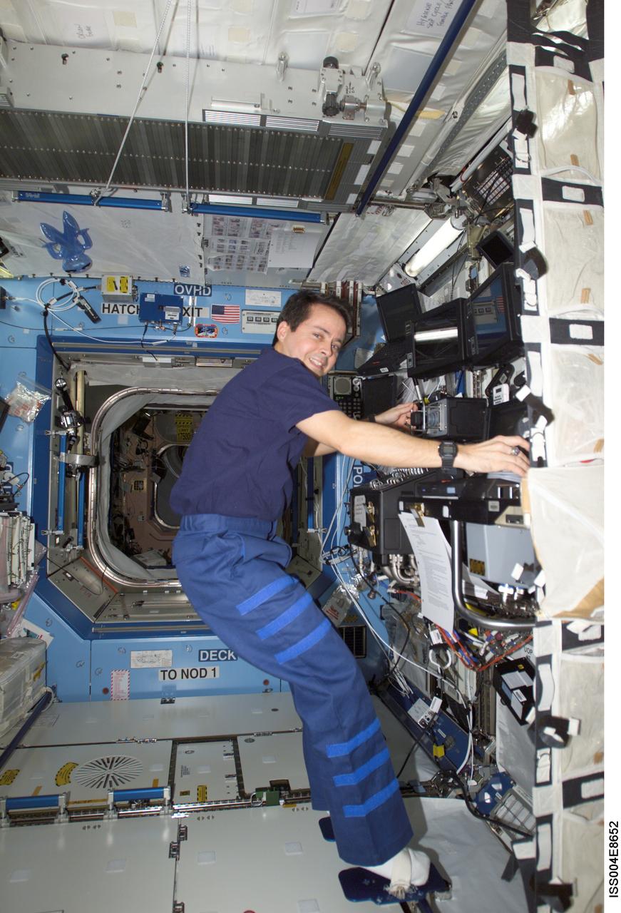 ISS004-E-8652 (14 March 2002) --- Astronaut Daniel W. Bursch, Expedition Four flight engineer, works the controls of the Canadarm2, or Space Station Remote Manipulator System (SSRMS) in the Destiny laboratory on the International Space Station (ISS). This image was taken with a digital still camera.