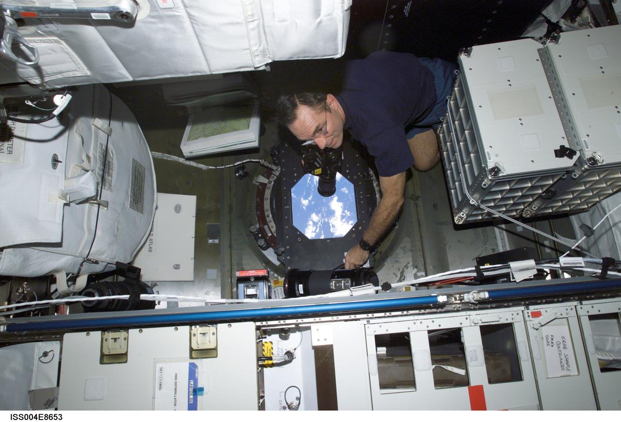 ISS004-E-8653 (14 March 2002) --- Astronaut Carl E. Walz, Expedition Four flight engineer, takes Earth observation photos from the Destiny laboratory on the International Space Station (ISS). The image was taken with a digital still camera.