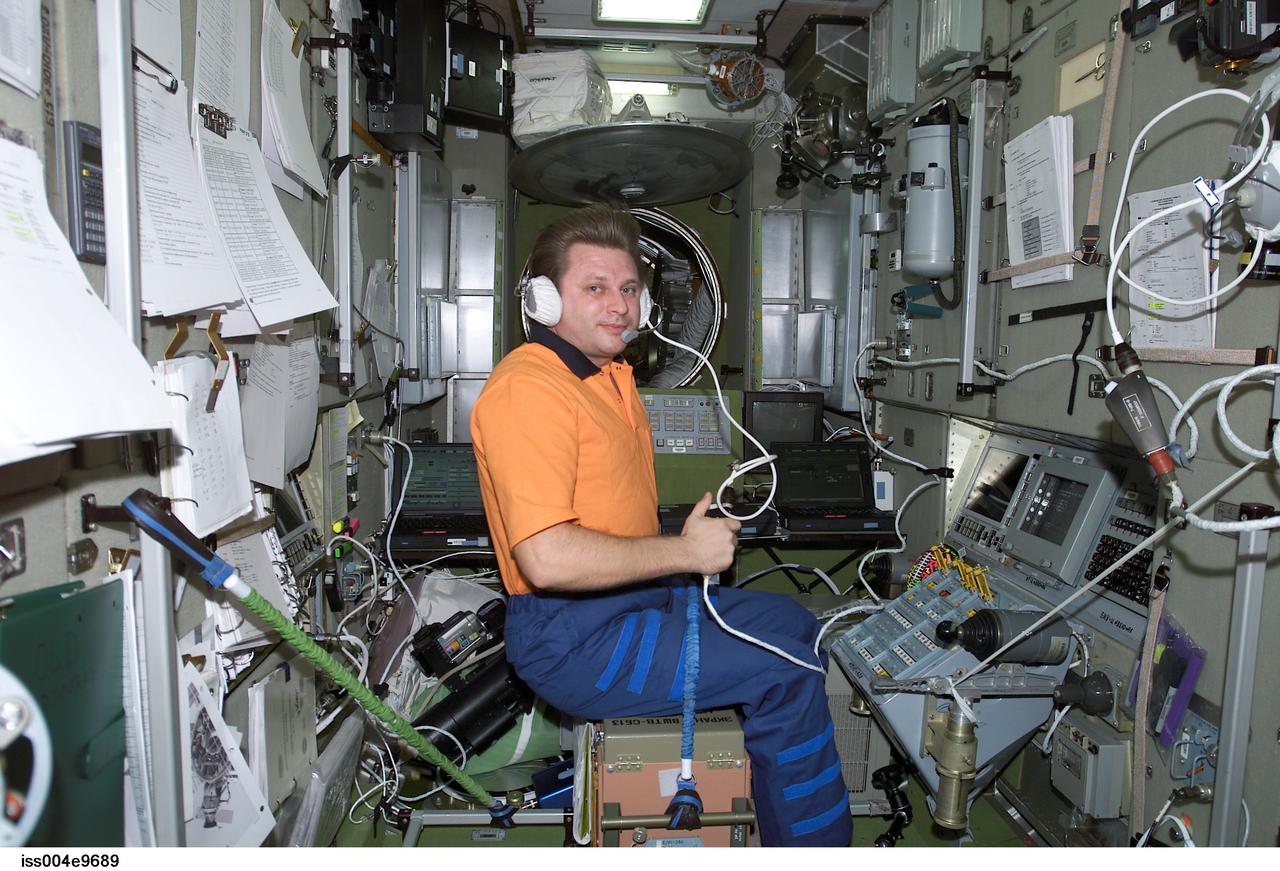 ISS004-E-9689 (25 March 2002) --- Cosmonaut Yury I. Onufrienko, Expedition Four mission commander, uses a communication system in the Zvezda Service Module on the International Space Station (ISS).