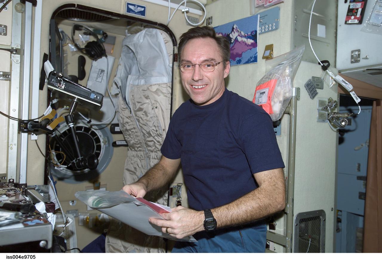 ISS004-E-9705 (25 March 2002) --- Astronaut Carl E. Walz, Expedition Four flight engineer, works in the Zvezda Service Module on the International Space Station (ISS).