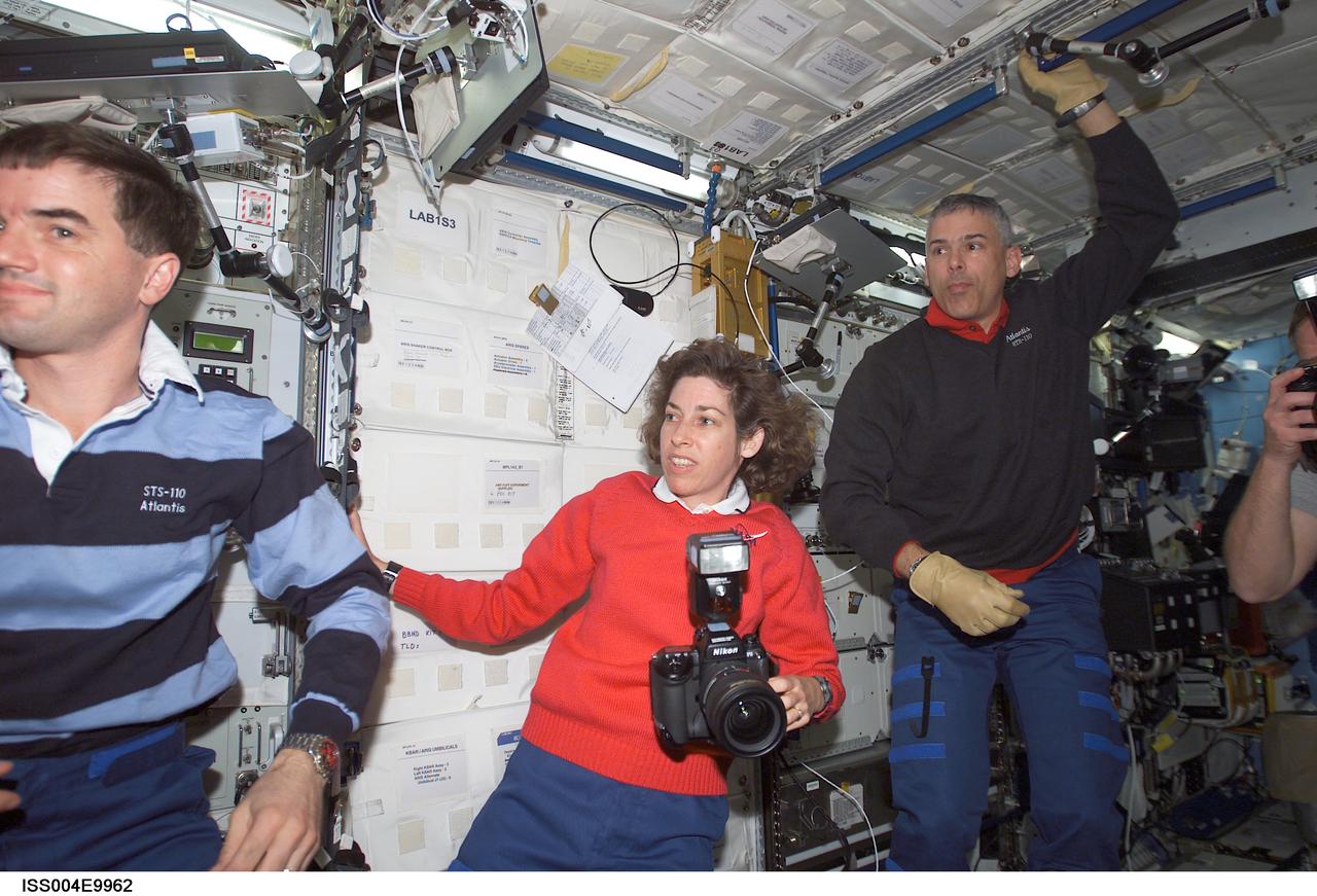 ISS004-E-9962 (10 April 2002) --- Astronauts Rex J. Walheim (left), Ellen Ochoa, and Lee M. E. Morin, all STS-110 mission specialists, are photographed in the Destiny laboratory on the International Space Station (ISS).