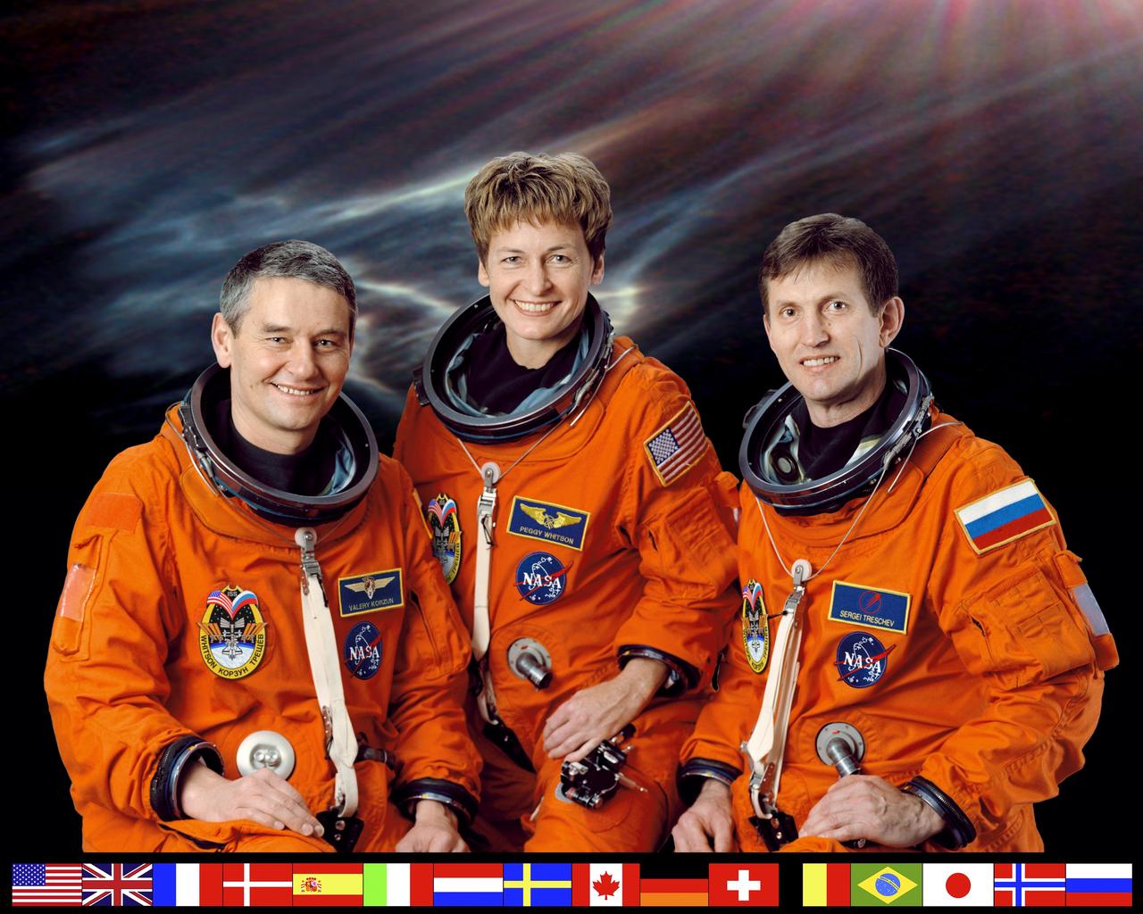 ISS005-S-002 (February 2002) --- Cosmonaut Valeri G. Korzun (left), Expedition Five mission commander; astronaut Peggy A. Whitson and cosmonaut Sergei Y. Treschev, both flight engineers, attired in training versions of the shuttle launch and entry suit, pause from their training schedule for a crew portrait.  The three will be launched to the International Space Station (ISS) in  early spring of this year aboard the Space Shuttle Atlantis.  Korzun and Treschev represent the Russian Aviation and Space Agency (Rosaviakosmos).