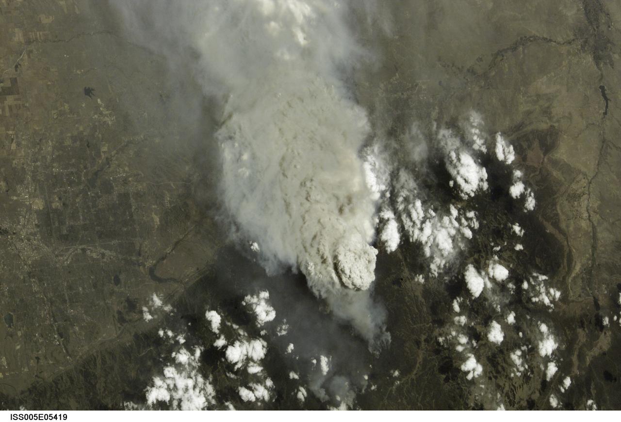 ISS005-E-5419  (18 June 2002) --- This photograph, taken by the International Space Station&#0146;s Expedition Five crew on June 18, 2002, shows the Hayman Fire burning in the foothills southwest of Denver. Astronauts use a variety of lenses and look angles as their orbits pass over wildfires to document the long-distance movements of smoke from the fires as well as details of the burning areas. In this perspective view,  Littleton, Chatfield Lake and the Arkansas River are all visible. The link [<http://eol.jsc.nasa.gov/scripts/sseop/photo.pl?mission=ISS005&roll=E&frame=5416> ] was provided by the Earth Sciences and Image Analysis Laboratory at Johnson Space Center. Additional images taken by astronauts and cosmonauts can be viewed at the NASA-JSC Gateway to Astronaut Photography of Earth [link to <http://eol.jsc.nasa.gov/> ].