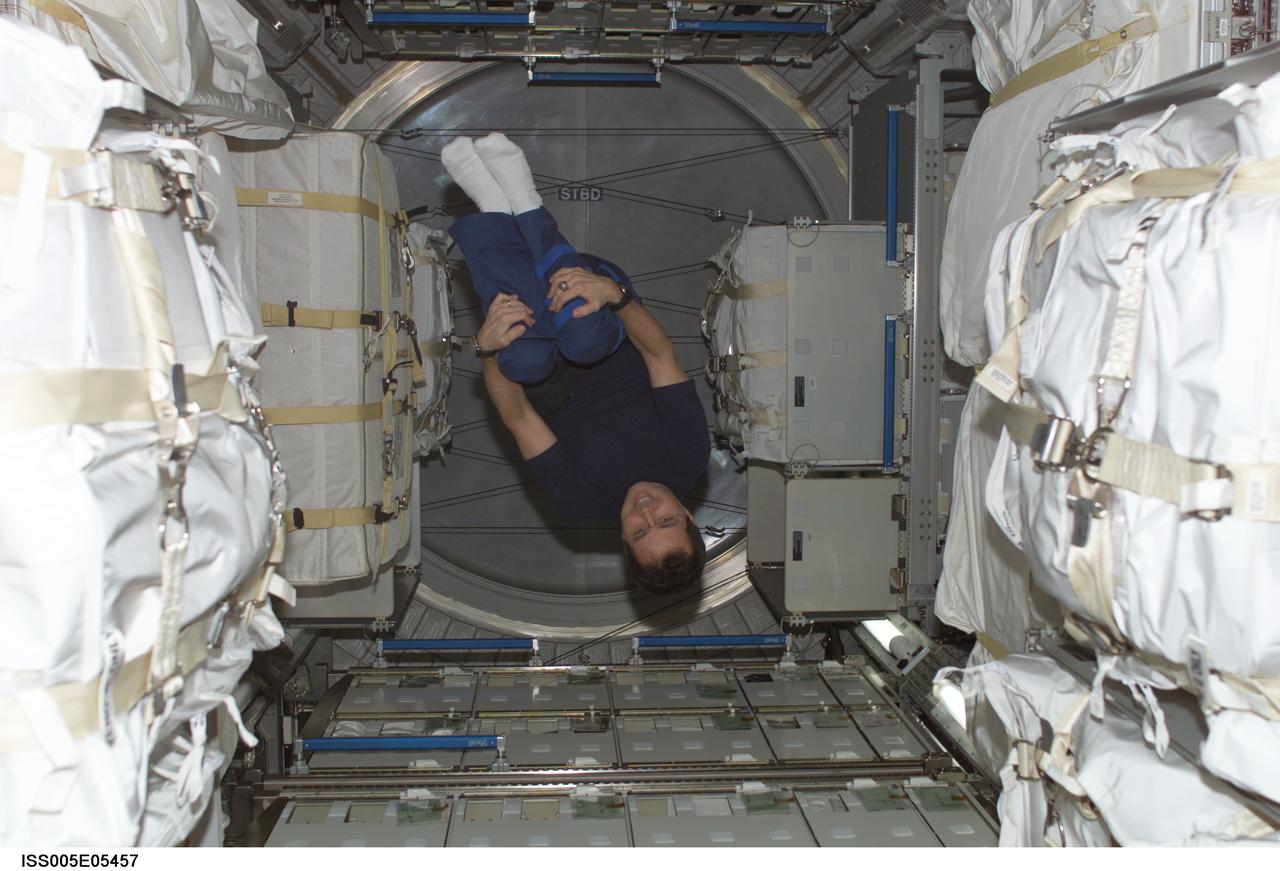 ISS005-E-05457 (June 2002) --- Astronaut Daniel W. Bursch, Expedition Four flight engineer, floats in the Leonardo Multi-Purpose Logistics Module (MPLM). Leonardo is one of three Multi-Purpose Logistics Modules built by the Italian Space Agency that serve as pressurized, reusable cargo carriers to ferry supplies, equipment and experiments between the ground and the space station.