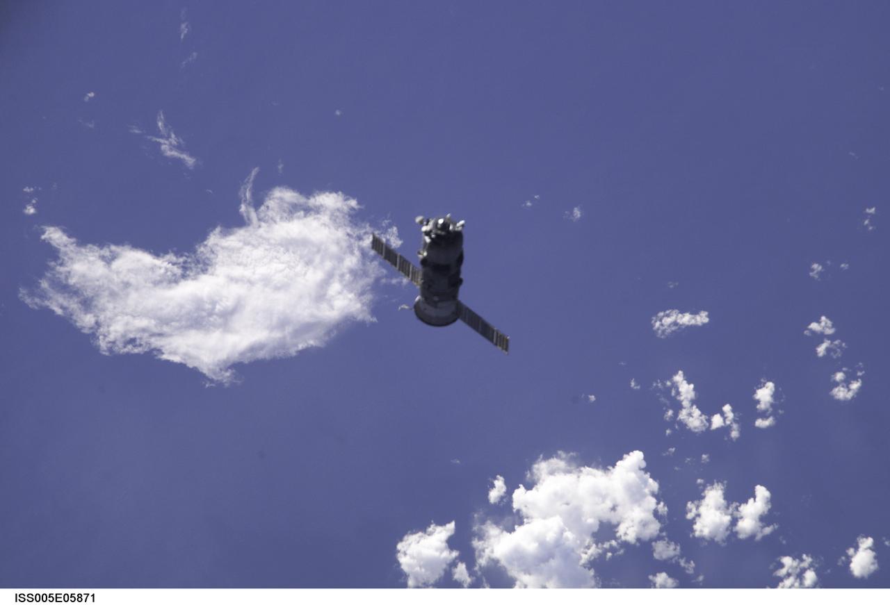 ISS005-E-05871 (25 June 2002) --- Backdropped by the blue and white Earth, an unpiloted Progress 7 supply vehicle departs from the Zvezda Service Modules docking port on the International Space Station (ISS) carrying its load of trash and unneeded equipment to be deorbited and burned up in the atmosphere. The undocking clears the way for the arrival of a new Progress 8, filled with fresh supplies, which is planned to dock to the station at 1:25 a.m. (CDT) on June 29, 2002.