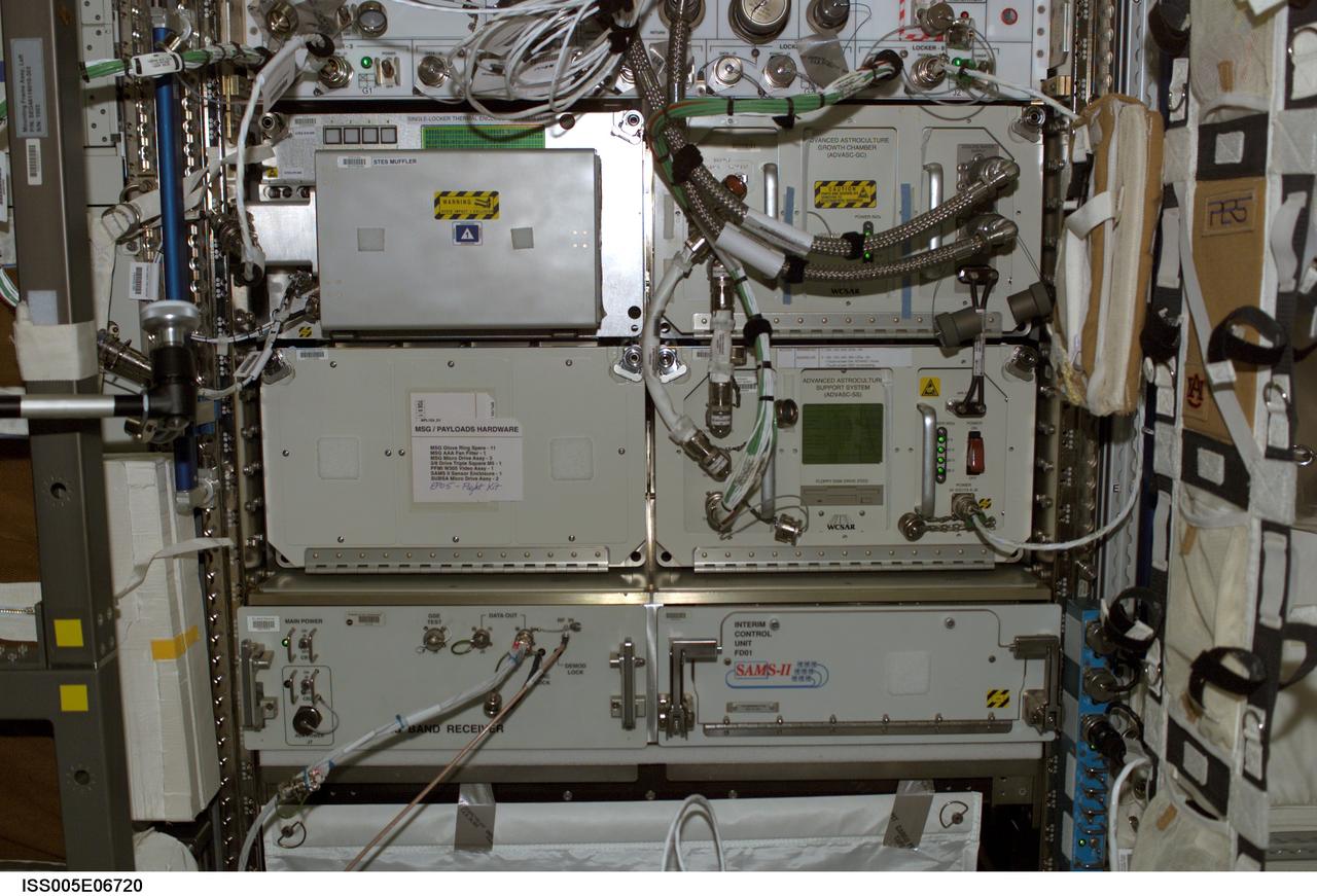 iss005e06720 (7/4/2002) --- Front view of Express Rack 4 in the U.S. Laboratory / Destiny taken during Expedition Five. Visible in the rack are the following items: Single-Locker Thermal Enclosure System (STES) Muffler, Advanced Astroculture Growth Chamber (ADVASC-GC), Advanced Astroculture Support System (ADVASC-SS). And Space Acceleration and Measurement System (SAMS) II.