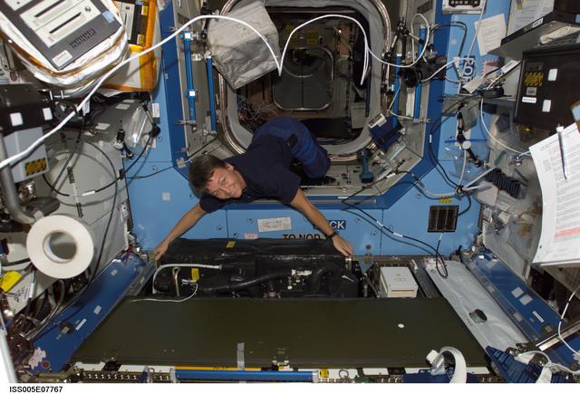 NASA image: Whitson moves equipment in the U.S. Laboratory during Expedition Five on the ISS
