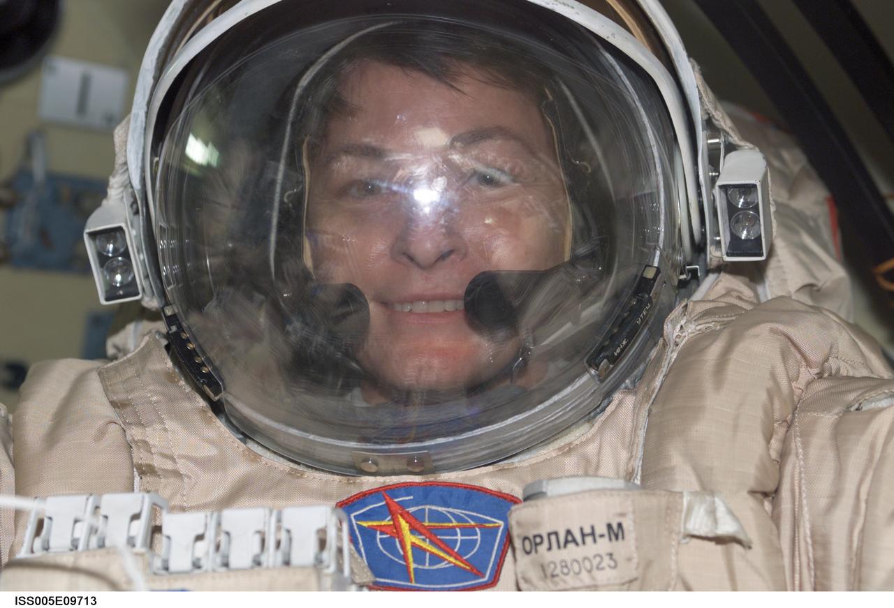 ISS005-E-09713 (14 August 2002) --- Astronaut Peggy A. Whitson, Expedition Five flight engineer, wears a Russian Orlan spacesuit as she prepares for an upcoming session of extravehicular activity (EVA) from the Pirs docking compartment on the International Space Station (ISS). The spacewalk is scheduled for August 16, 2002, which will be the 42nd spacewalk at the station and the 17th based out of the station. Whitson and cosmonaut Valery G. Korzun, mission commander, will install six debris panels on the Zvezda Service Module. The panels are designed to shield Zvezda from potential space debris impacts.