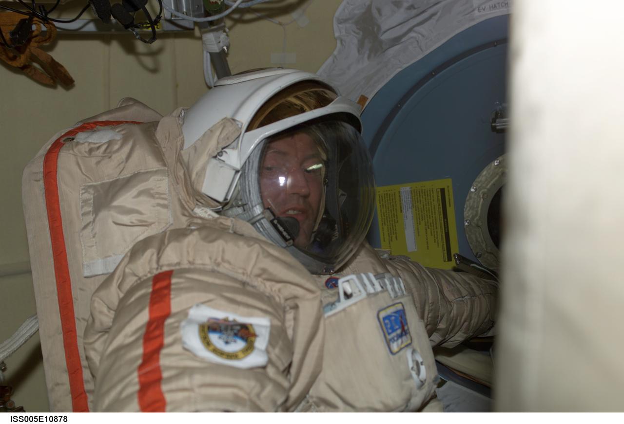 ISS005-E-10878 (24 August 2002) --- Cosmonaut Sergei Y. Treschev, Expedition Five flight engineer, attired in a Russian Orlan spacesuit, prepares for an upcoming session of extravehicular activity (EVA) scheduled for August 26, 2002. The EVA, from the Pirs docking compartment on the International Space Station (ISS), will be the 43rd spacewalk at the station and the 18th based out of the station. Treschev represents Rosaviakosmos.