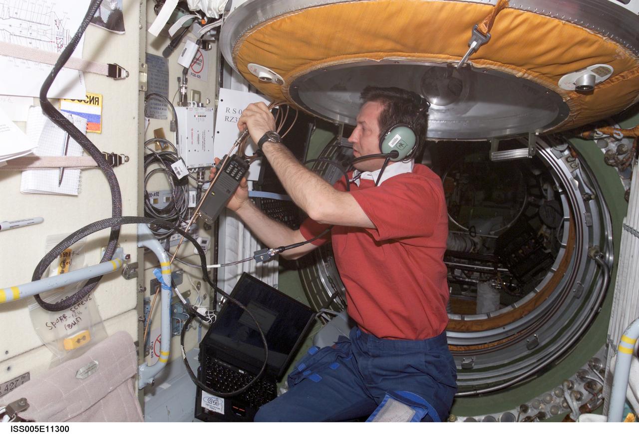 ISS005-E-11300 (27 August 2002) --- Cosmonaut Sergei Y. Treschev, Expedition Five flight engineer, uses an amateur radio in the functional cargo block (FGB) on the International Space Station (ISS). Treschev represents Rosaviakosmos.