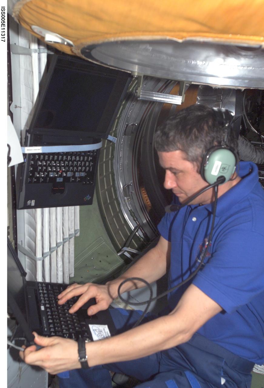 ISS005-E-11317 (27 August 2002) --- Cosmonaut Valery G. Korzun, Expedition Five mission commander, uses an amateur radio in the functional cargo block (FGB) on the International Space Station (ISS). Korzun represents Rosaviakosmos.