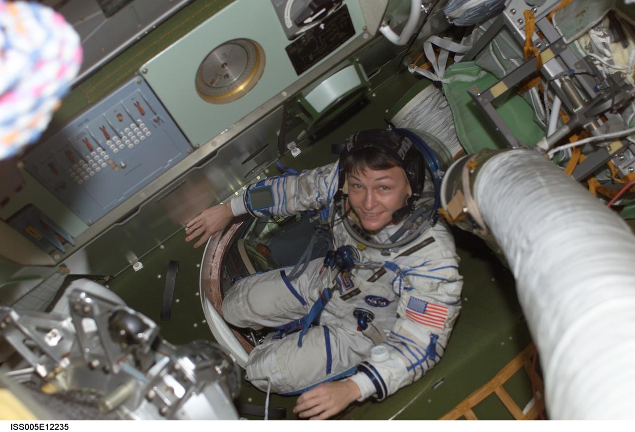 ISS005-E-12235 (3 September 2002) --- Astronaut Peggy A. Whitson, Expedition Five flight engineer, wearing a Russian Sokol suit, is pictured in a Soyuz spacecraft that is docked to the International Space Station (ISS).