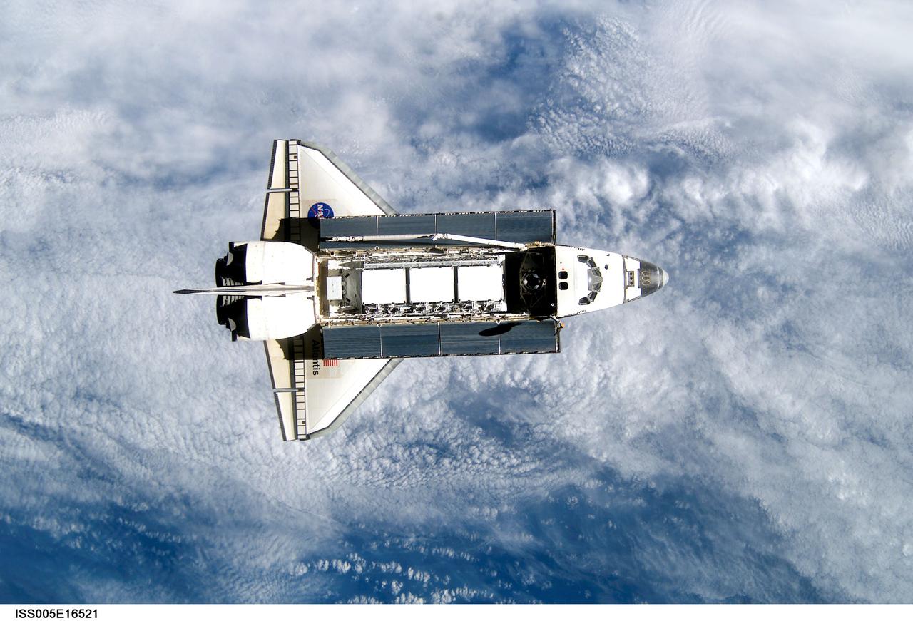 ISS005-E-16521 (9 October 2002) --- Backdropped against a blue and white Earth, this view of the Space Shuttle Atlantis was photographed by an Expedition Five crewmember onboard the International Space Station (ISS) during rendezvous and docking operations. Docking occurred at 10:17 a.m. (CDT) on October 9, 2002. The S1 (S-One) Truss, which is scheduled to be attached to the station and outfitted during three spacewalks, can be seen in Atlantis&#0146; cargo bay.