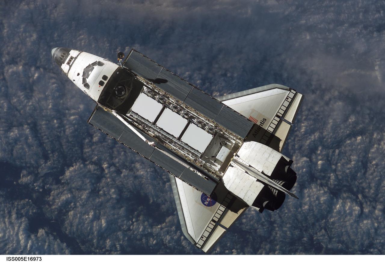 ISS005-E-16973 (9 October 2002) --- Backdropped against a blue and white Earth, this view of the Space Shuttle Atlantis was photographed by an Expedition Five crewmember onboard the International Space Station (ISS) during rendezvous and docking operations. Docking occurred at 10:17 a.m. (CDT) on October 9, 2002. The Starboard One (S-1) Truss, which was later attached to the station and outfitted during three spacewalks, can be seen in Atlantis&#0146; cargo bay.