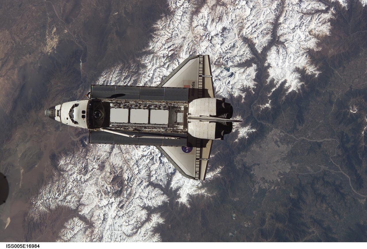 ISS005-E-16984 (9 October 2002) --- Backdropped against snowcapped Cordon del Plata of the Andes mountains, this view of the Space Shuttle Atlantis was photographed by an Expedition Five crewmember onboard the International Space Station (ISS) during rendezvous and docking operations. Docking occurred at 10:17 a.m. (CDT) on October 9, 2002. The Starboard One (S-1) Truss, which was later attached to the station and outfitted during three spacewalks, can be seen in Atlantis’ cargo bay. Argentina is visible in the upper left frame and Santiago, Chile is visible in the lower right frame.