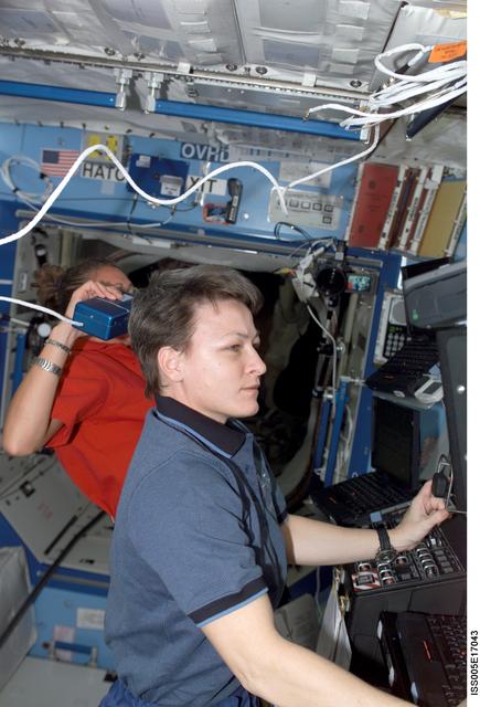 NASA image: Whitson and Magnus working in the U.S. Laboratory during Expedition Five on the ISS
