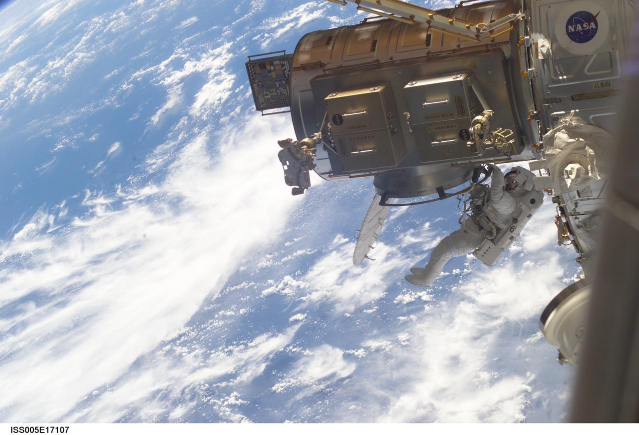 ISS005-E-17107 (10 October 2002) --- Astronaut Piers J. Sellers, STS-112 mission specialist, exits the Quest Airlock on the International Space Station (ISS) to begin the first scheduled session of extravehicular activity (EVA) for the STS-112 mission. Astronaut David A. Wolf (out of frame), mission specialist, joined Sellers on the spacewalk.