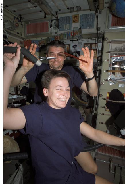 NASA image: Whitson receives haircut from Korzun in Zvezda