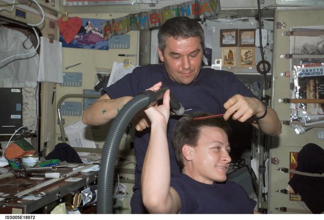 NASA image: Whitson receives haircut from Korzun in Zvezda