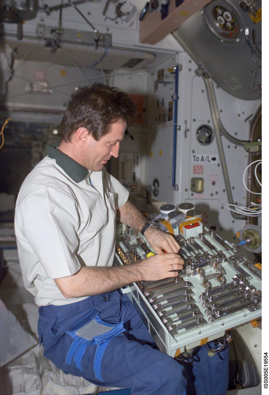 ISS005-E-19554 (2 November 2002) --- Cosmonaut Sergei Y. Treschev, Expedition Five flight engineer, works with various tools in the Unity node on the International Space Station (ISS). Treschev represents Rosaviakosmos.