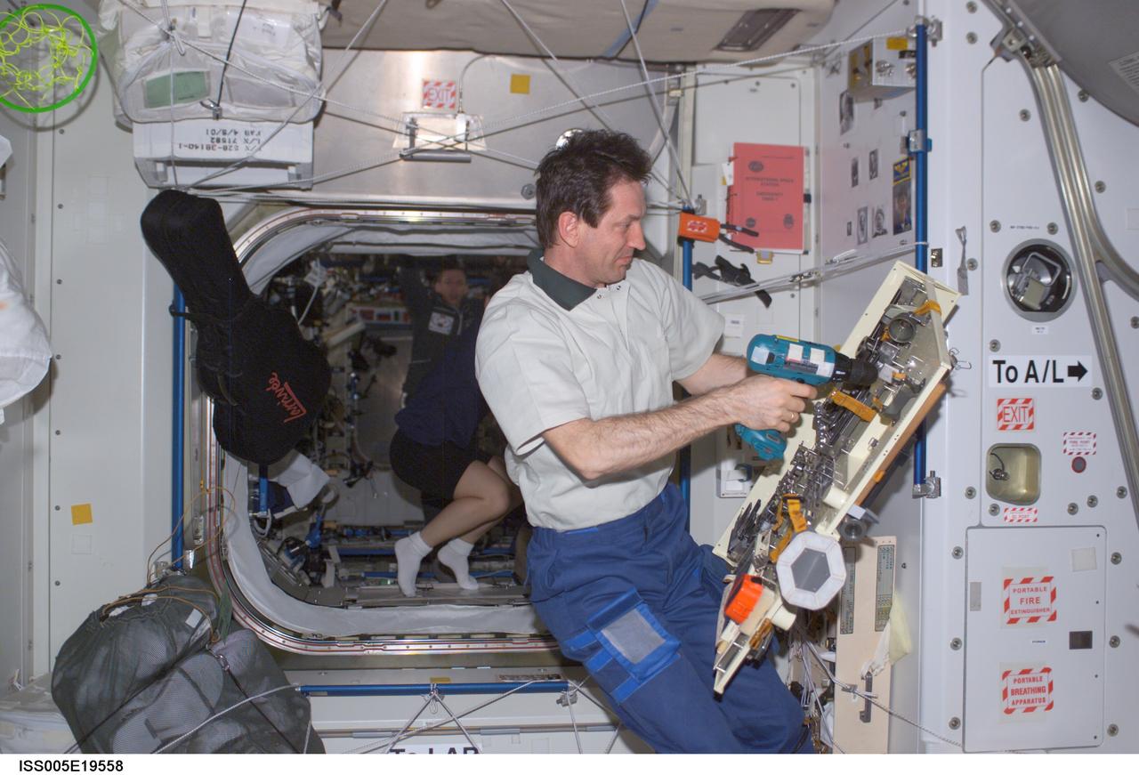 ISS005-E-19558 (2 November 2002) --- Cosmonaut Sergei Y. Treschev, Expedition Five flight engineer, works with various tools in the Unity node on the International Space Station (ISS). Treschev represents Rosaviakosmos.