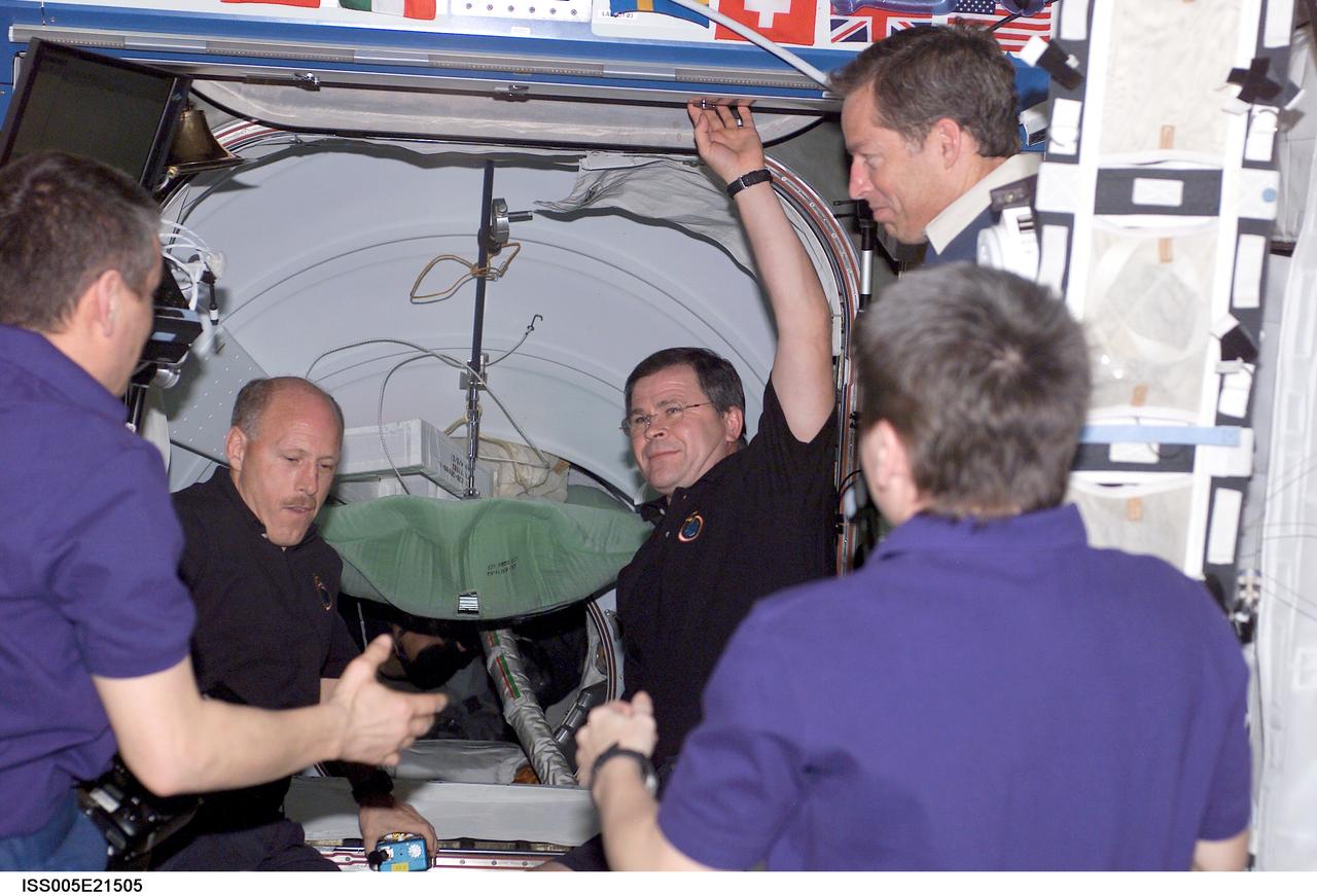 ISS005-E-21505 (25 November 2002) --- The Expedition Five crewmembers greet the Expedition Six and STS-113 crewmembers when the hatch to the Pressurized Mating Adapter 2 (PMA-2) on the International Space Station (ISS) was opened for the STS-113 ingress. Pictured are cosmonaut Valery G. Korzun (back to camera, left), Expedition Five mission commander; astronaut Peggy A. Whitson (back to camera, right), Expedition Five NASA ISS science office. Pictured, left to right (background), are astronaut Kenneth D. Bowersox, Expedition Six mission commander; cosmonaut Nikolai M. Budarin, Expedition Six flight engineer; and astronaut James D. Wetherbee, STS-113 mission commander.  Korzun and Budarin represent Rosaviakosmos.