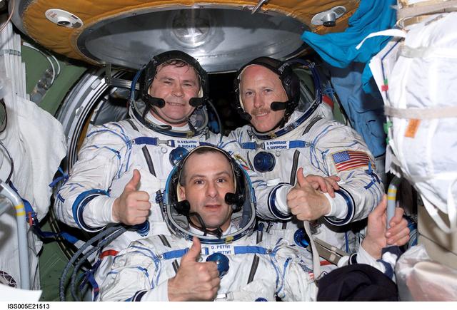 NASA image: Expedition Six crewmembers pose in the FGB during Expedition Five on the ISS