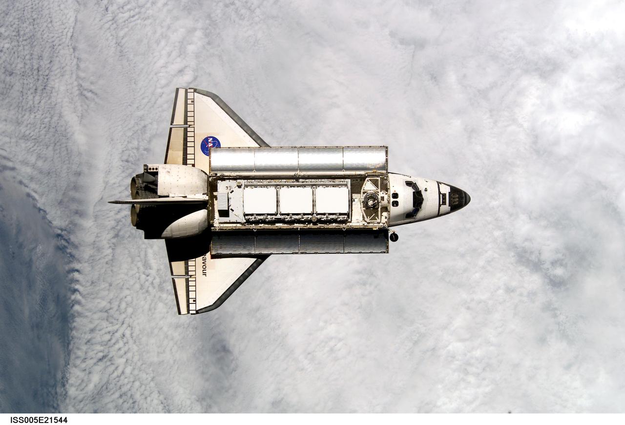 ISS005-E-21544 (25 November 2002) --- Backdropped by a blanket of clouds, the Space Shuttle Endeavour approaches the International Space Station (ISS) during STS-113 rendezvous and docking operations. Docking occurred at 3:59 p.m. (CST) on November 25, 2002. The Port One (P1) truss, which was later to be attached to the station and outfitted during three spacewalks, can be seen in Endeavour's cargo bay.