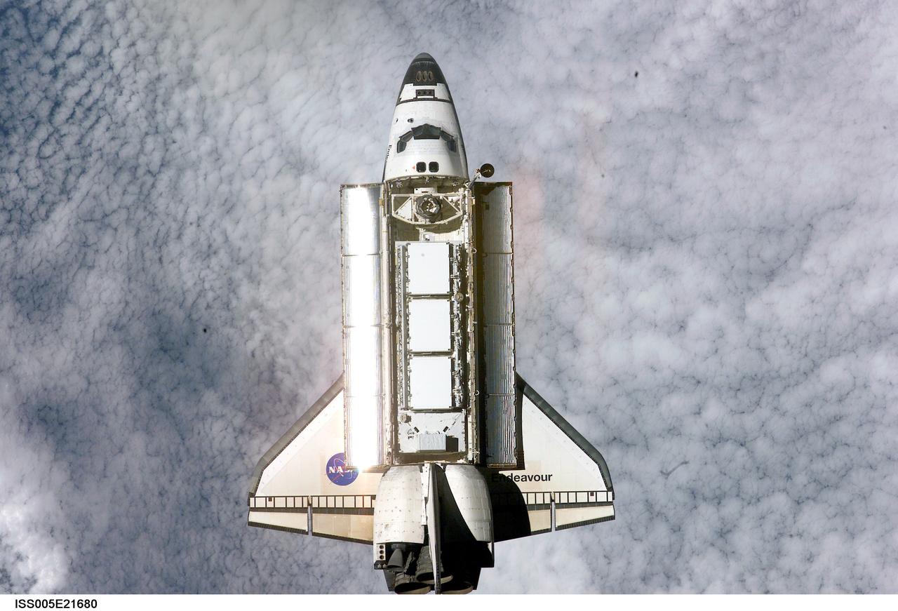ISS005-E-21680 (25 November 2002) --- Backdropped by a blanket of clouds, the Space Shuttle Endeavour approaches the International Space Station (ISS) during STS-113 rendezvous and docking operations. Docking occurred at 3:59 p.m. (CST) on November 25, 2002. The Port One (P1) truss, which was later attached to the station and outfitted during three spacewalks, can be seen in Endeavour&#0146;s cargo bay.