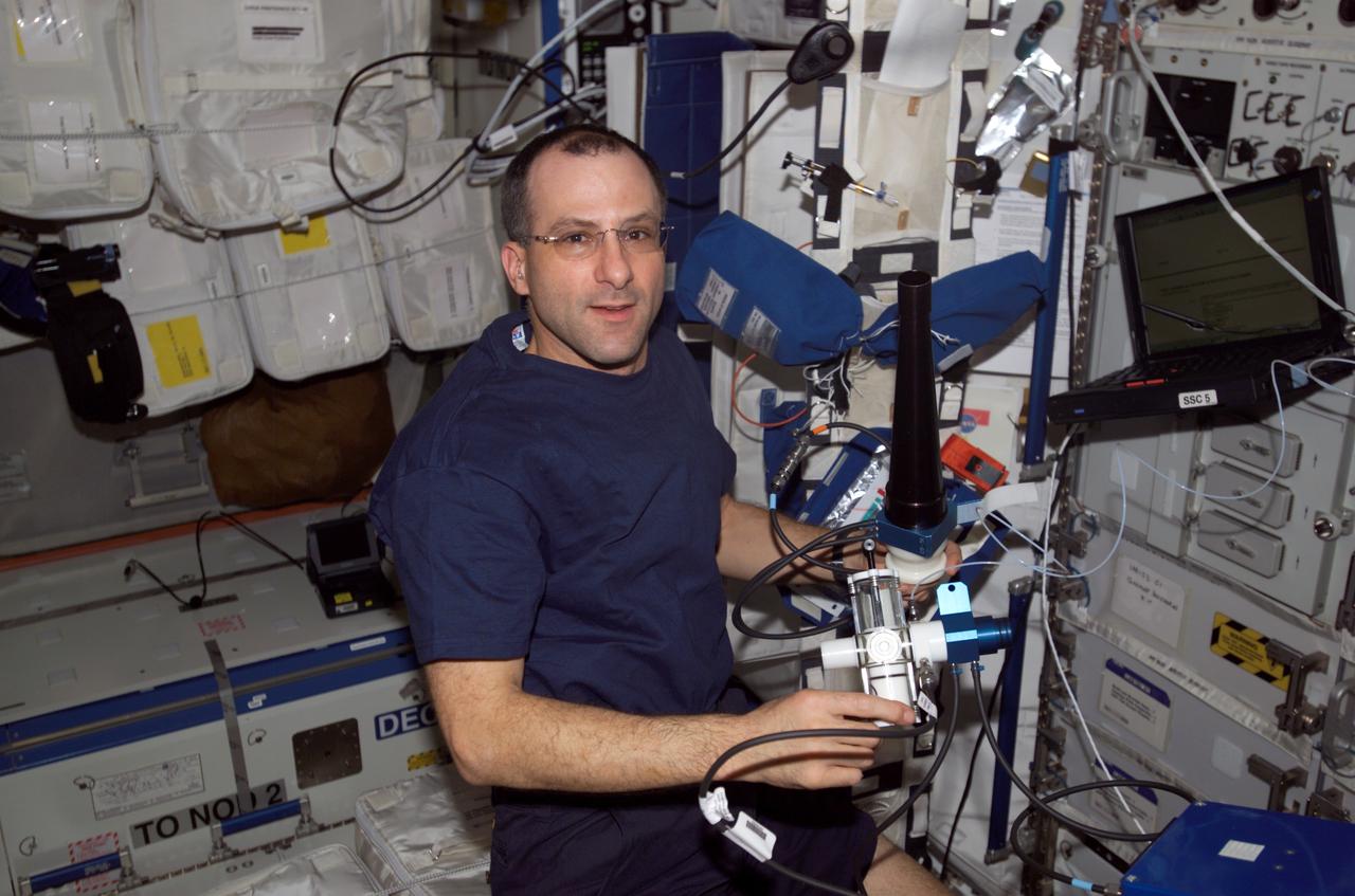 ISS006-E-07133 (9 December 2002) --- Astronaut Donald R. Pettit, Expedition 6 NASA ISS science officer, works to set up Pulmonary Function in Flight (PuFF) hardware in preparation for a Human Research Facility (HRF) experiment in the Destiny laboratory on the International Space Station (ISS). Expedition 6 is the fourth and final expedition crew to perform the HRF/PuFF Experiment on the ISS.