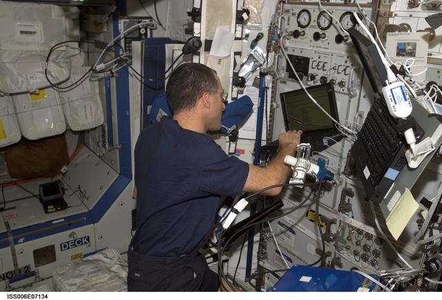 NASA image: Expedition Six Flight Engineer Donald R. Pettit is loading software on PC in U.S. Lab