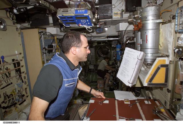 NASA image: Expedition Six Flight Engineer Pettit is looking at a procedures checklist