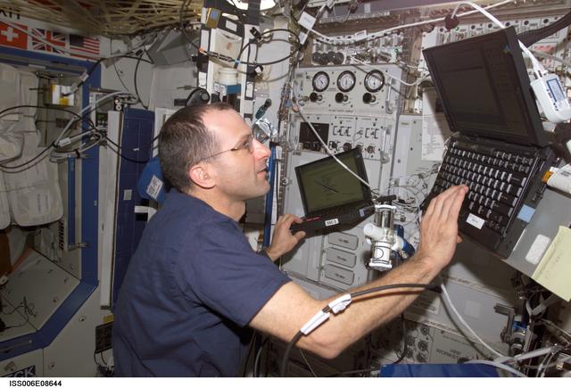 NASA image: Expedition Six Flight Eng Donald R. Pettit is setting up the Pulmonary Function in Flight hardware
