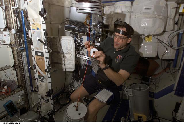NASA image: Pettit conducts maintenance on the RED equipment in the U.S. Laboratory