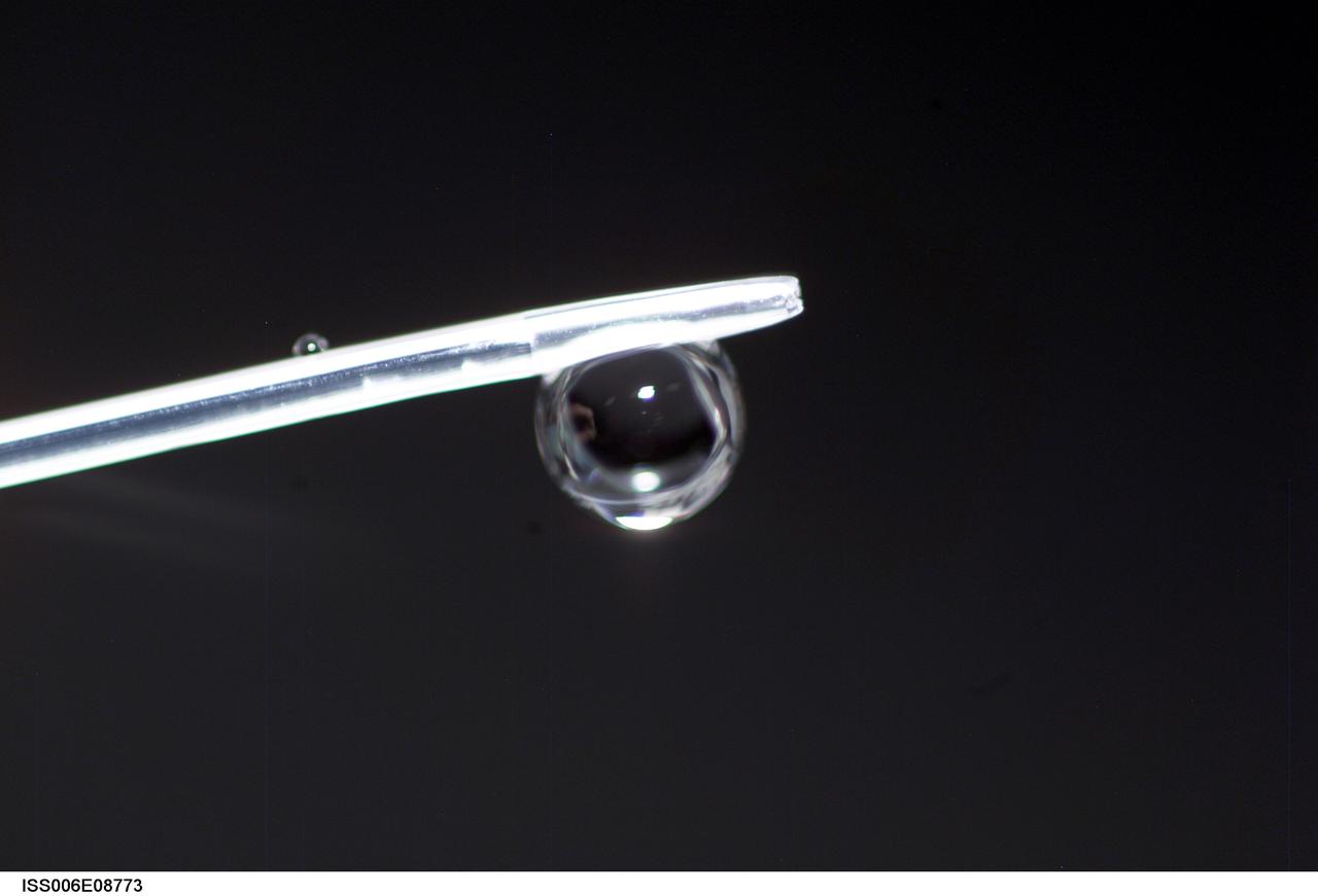 ISS006-E-08773 (14 December 2002) --- View of a bubble formed as a result of a Zeolite Crystal Growth (ZCG) experiment in the Destiny laboratory on the International Space Station (ISS). Expedition Six Commander Kenneth D. Bowersox used a Space Station drill to mix 12 Zeolite samples in clear tubes. Scientists on the ground watching on TV noticed bubbles in the samples. Bowersox used a modified mixing procedure to process autoclaves to isolate bubbles.  He re-inserted the samples in the ZCG furnace in Express Rack 2 in the U.S. laboratory/Destiny. This experiment has shown that the bubbles could cause larger number of smaller deformed crystals to grow. Bowersox rotated the samples so that the heavier fluid was thrown to the outside while the lighter bubbles stayed on the inside.