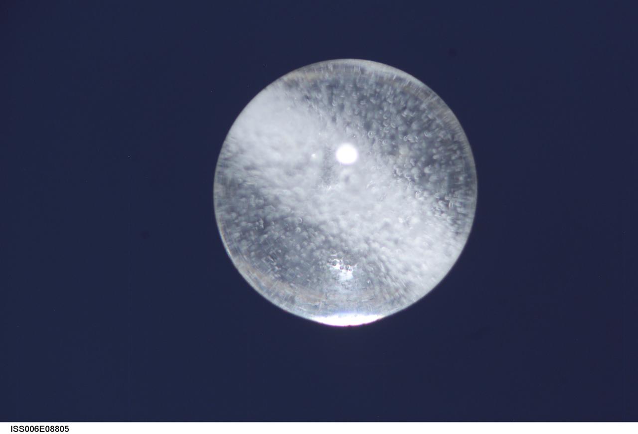 ISS006-E-08805 (14 December 2002) --- View of a bubble formed as a result of a Zeolite Crystal Growth (ZCG) experiment in the Destiny laboratory on the International Space Station (ISS). Expedition Six Commander Kenneth D. Bowersox used a Space Station drill to mix 12 Zeolite samples in clear tubes. Scientists on the ground watching on TV noticed bubbles in the samples. Bowersox used a modified mixing procedure to process autoclaves to isolate bubbles.  He re-inserted the samples in the ZCG furnace in Express Rack 2 in the U.S. laboratory/Destiny. This experiment has shown that the bubbles could cause larger number of smaller deformed crystals to grow. Bowersox rotated the samples so that the heavier fluid was thrown to the outside while the lighter bubbles stayed on the inside.