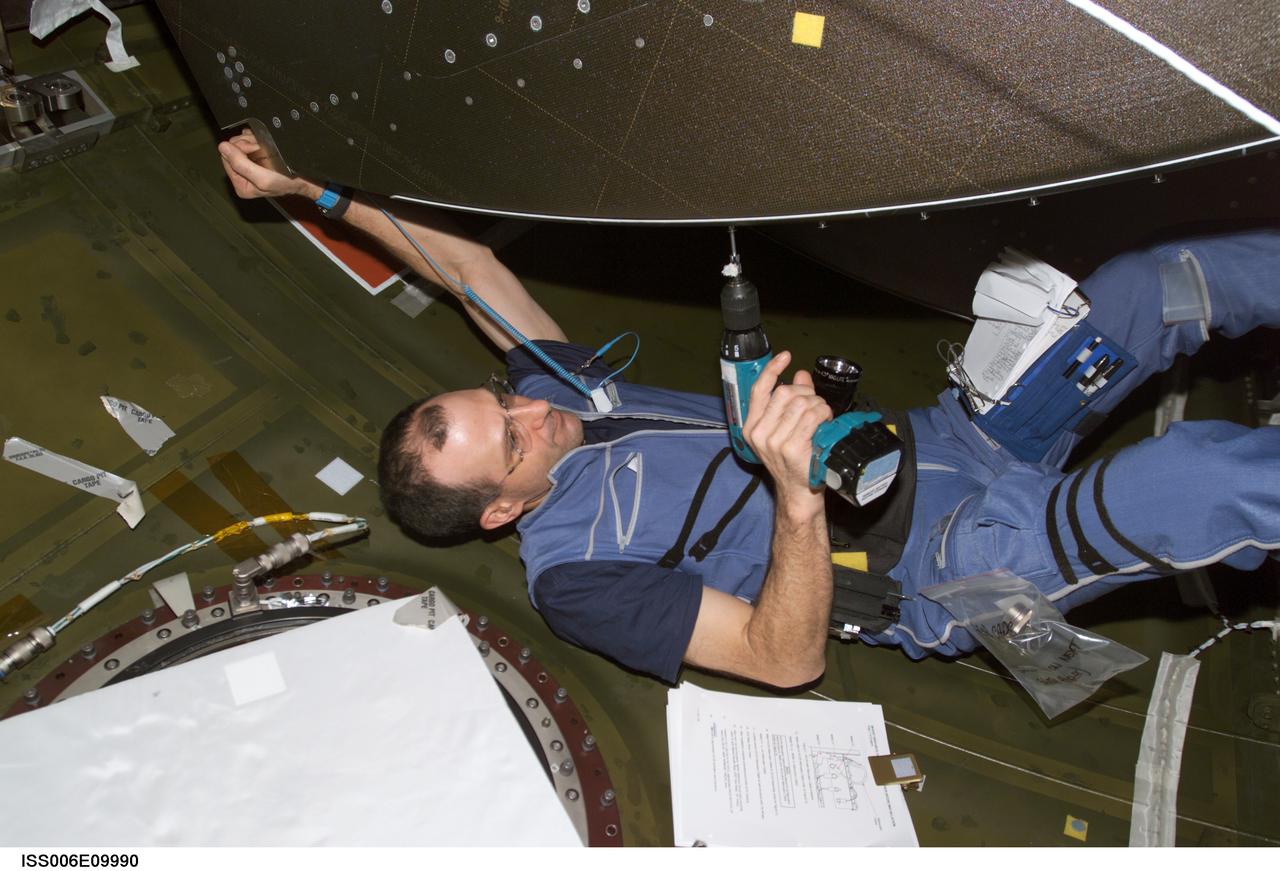 ISS006-E-09990 (20 December 2002) --- Astronaut Donald R. Pettit, Expedition Six NASA ISS science officer, performs in-flight maintenance (IFM) in the Destiny laboratory on the International Space Station (ISS).