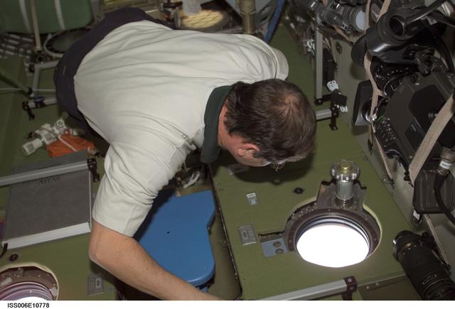 NASA image: Budarin looks through a nadir window in the Service Module
