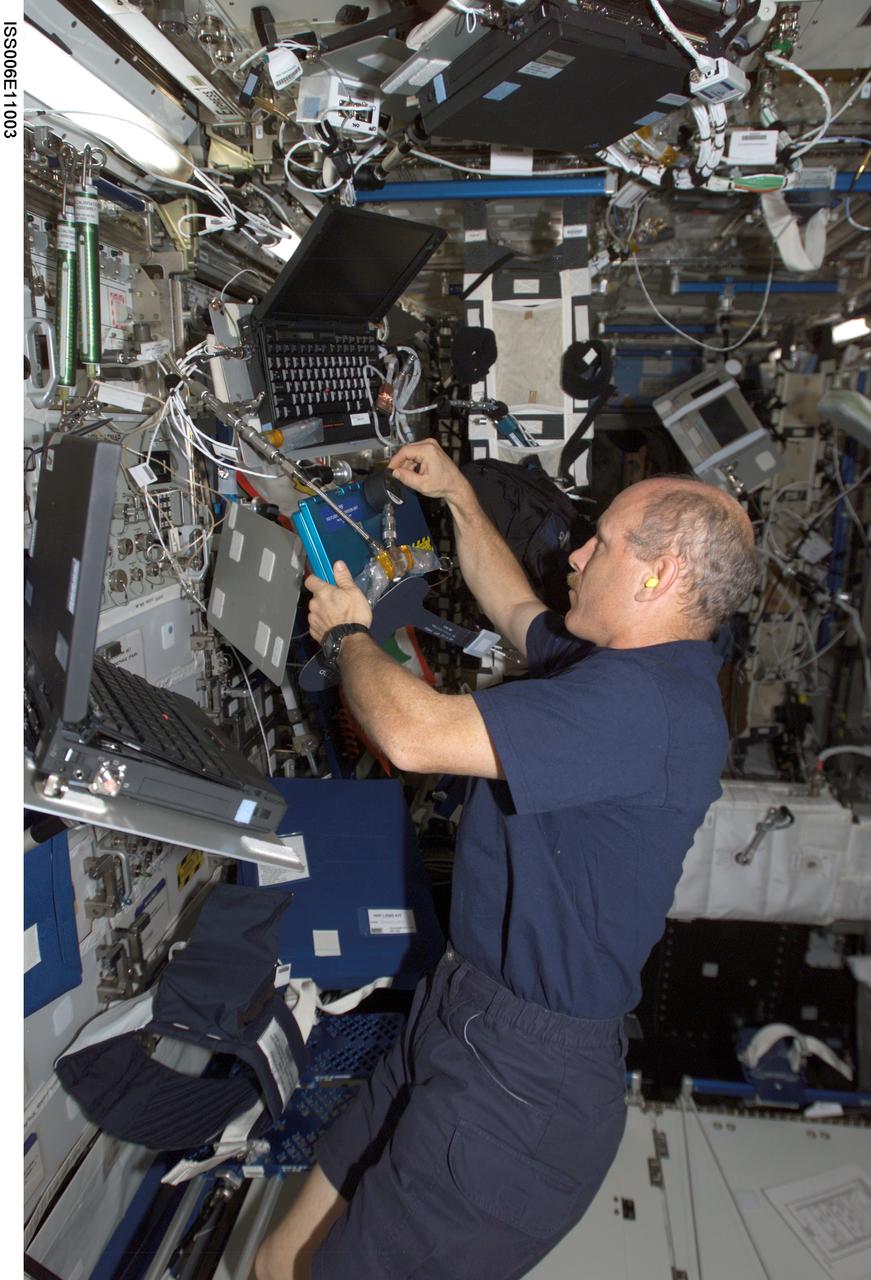ISS006-E-11003 (24 December 2002) --- Astronaut Kenneth D. Bowersox, Expedition Six mission commander, works in the Destiny laboratory on the International Space Station (ISS).