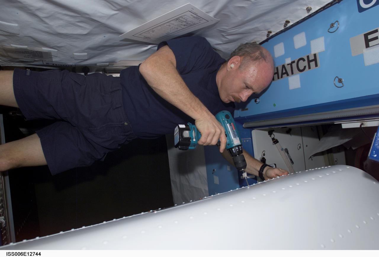 ISS006-E-12744 (30 December 2002) --- Astronaut Kenneth D. Bowersox, Expedition Six mission commander, performs in-flight maintenance (IFM) in the Destiny laboratory on the International Space Station (ISS).